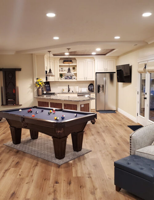 Finished basement remodel with game room in Utah by Pro-Worx Construction with custom flooring and modern design
