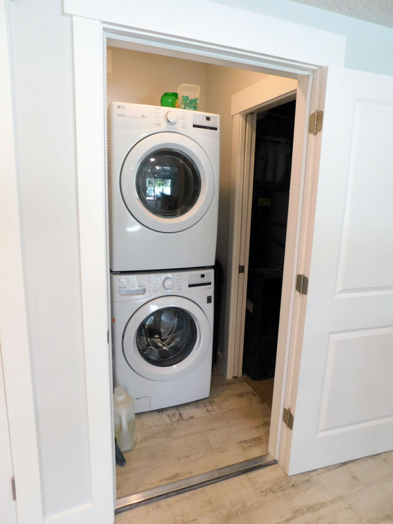 stacked dryer and washer laundry space by pro worx construction in utah