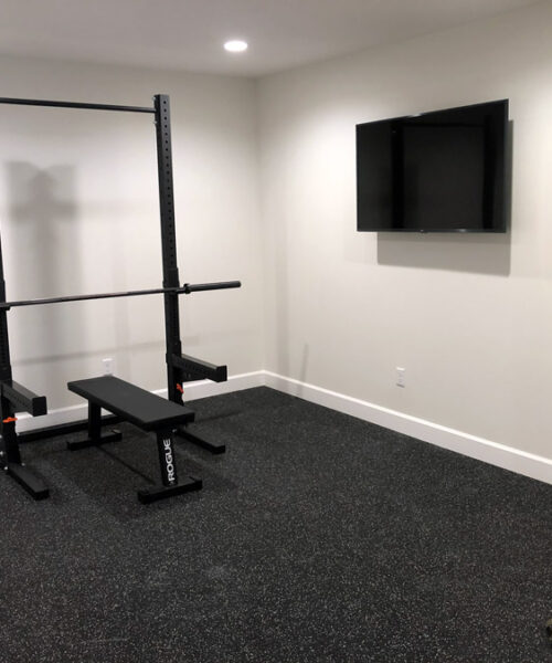 gym with a wall tv constructed by pro worx construction in utah