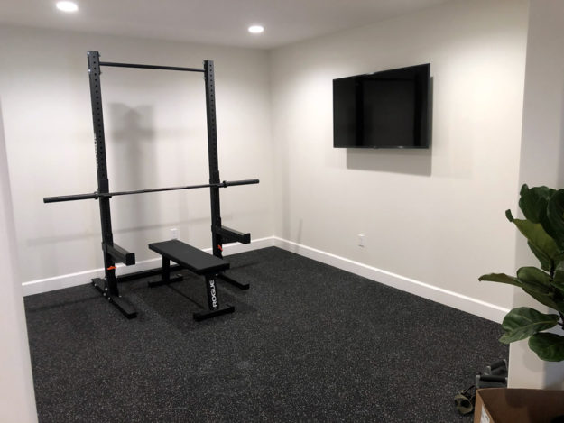 gym with a wall tv constructed by pro worx construction in utah
