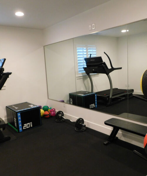 gym and workout room with large mirrors built by pro worx construction in utah