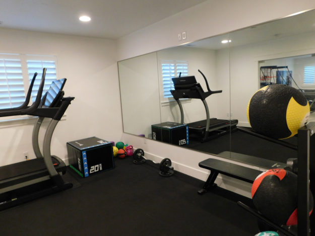 gym and workout room with large mirrors built by pro worx construction in utah