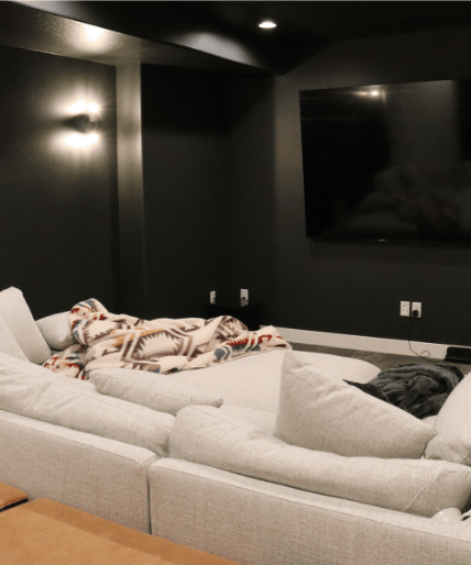 complete home theater during basement finishing project with soft lighting by pro worx construction in utah