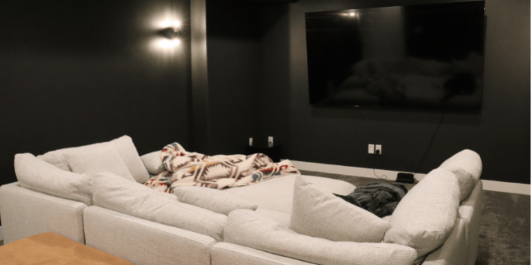 complete home theater during basement finishing project with soft lighting by pro worx construction in utah