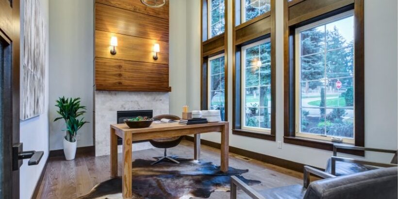 home office with large fireplace and large windows