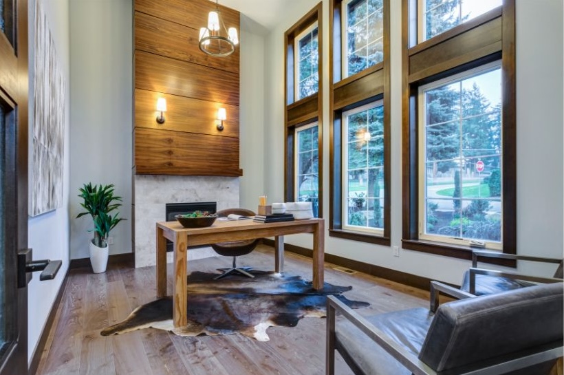 home office with large fireplace and large windows