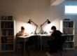 Two boys with bookshelves as dividers