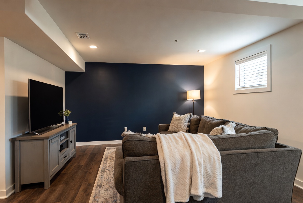 Bold navy painted accent wall in a utah basement